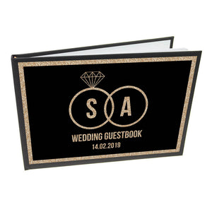 Personalisiertes Hochzeitsgästebuch mit schwarzen und goldenen Ringen